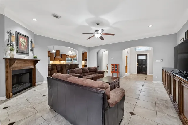 a living room with furniture a fireplace and a flat screen tv