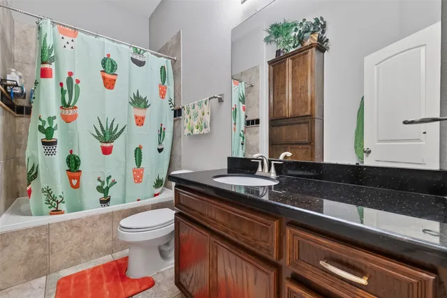 a bathroom with a sink a toilet and a shower curtain