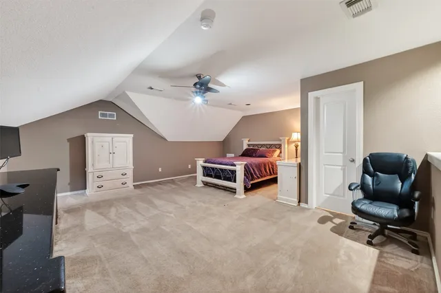 a view of a livingroom with furniture and a ceiling fan