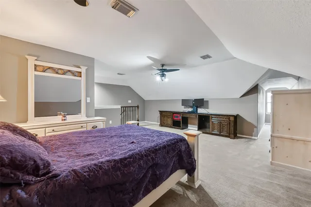 a bedroom with a bed and ceiling fan