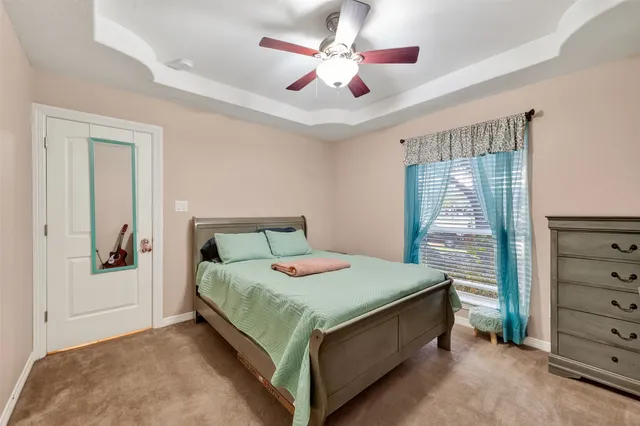 a bedroom with a bed and a dresser