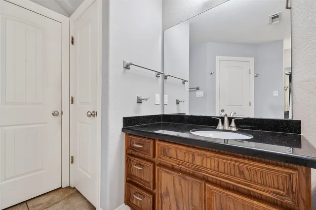 a bedroom with a bed and a flat tv screen on a dresser