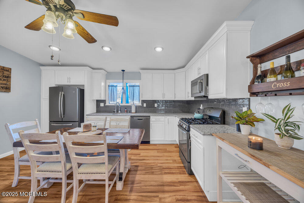 7 Maple Lane Howell, NJ 07731 - Photo 14 of 32 a kitchen with stainless steel appliances kitchen island granite countertop a sink and cabinets