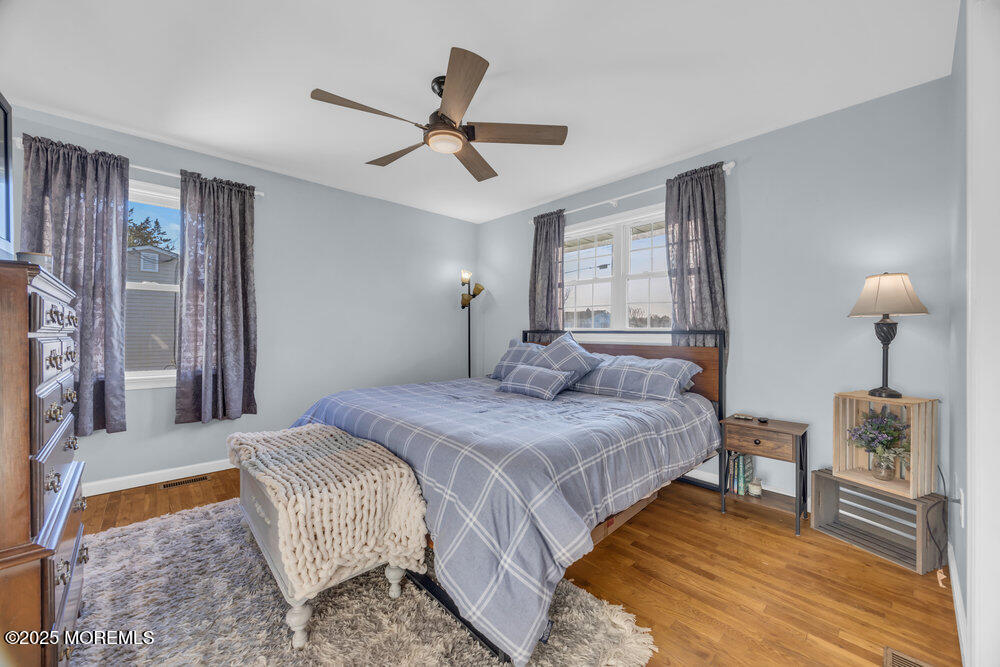 7 Maple Lane Howell, NJ 07731 - Photo 15 of 32 a bedroom with a bed and a chandelier