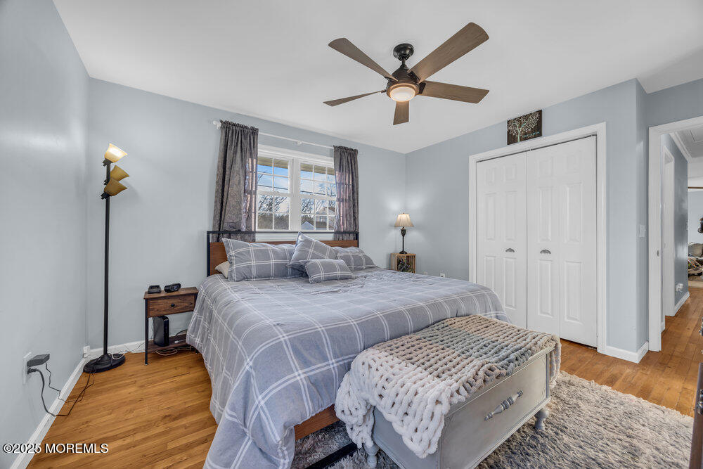 7 Maple Lane Howell, NJ 07731 - Photo 16 of 32 a bedroom with a bed a window and a chandelier