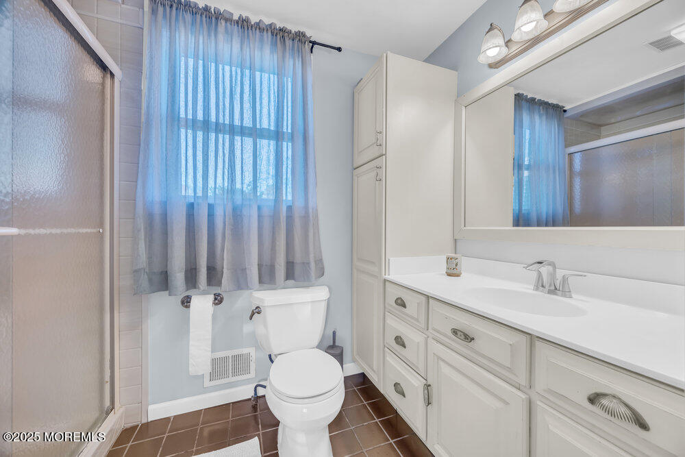 7 Maple Lane Howell, NJ 07731 - Photo 25 of 32 a bathroom with a sink toilet a mirror and shower