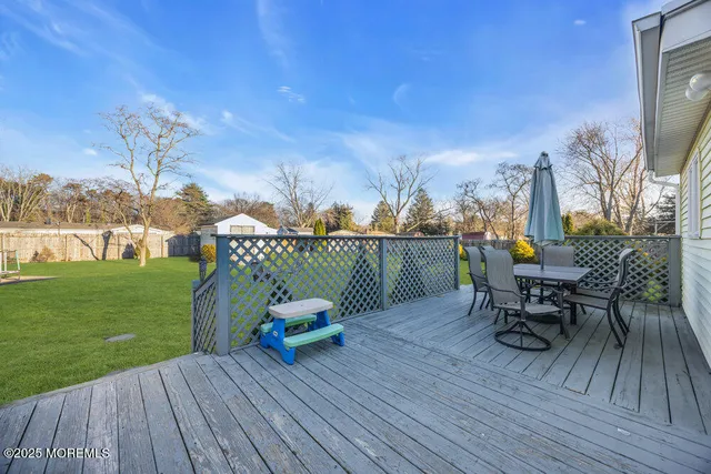 a view of a deck with table and chairs with wooden floor and fence