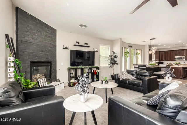 a living room with furniture a fireplace and a flat screen tv