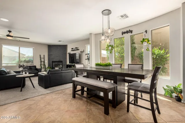 a kitchen with a table chairs stove and cabinets