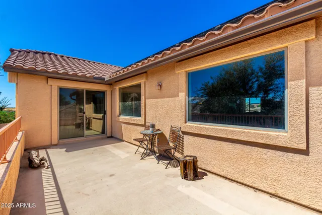 a view of a patio with a table and chairs in patio