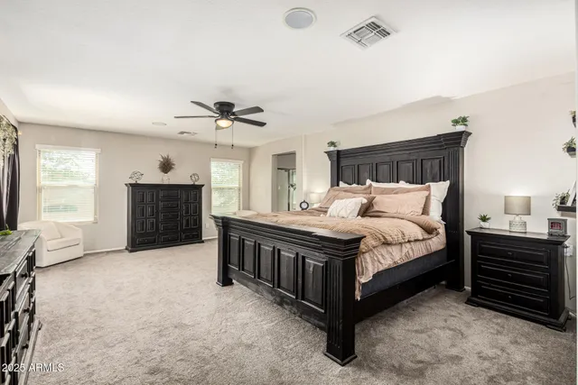 a bedroom with a bed dresser and a baby crib