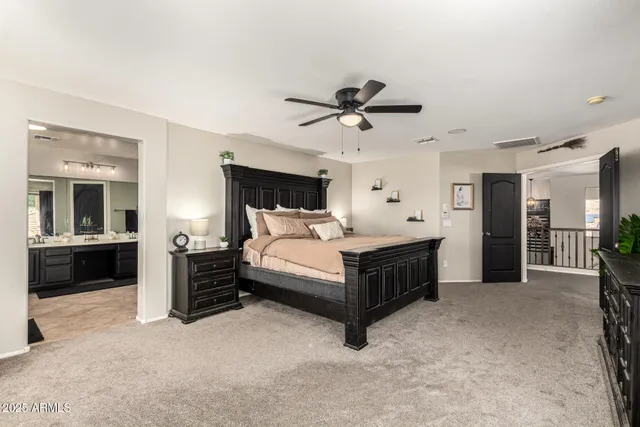 a spacious bedroom with a bed and a view of bedroom