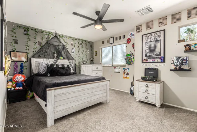 a bed room with furniture and a flat screen tv