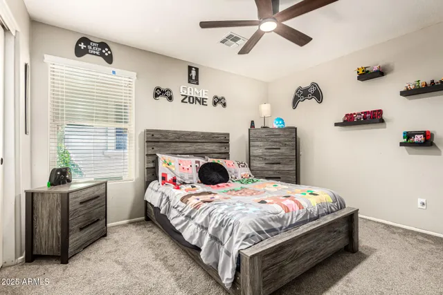 a bedroom with a bed and ceiling fan