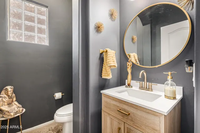 a bathroom with a toilet sink and mirror