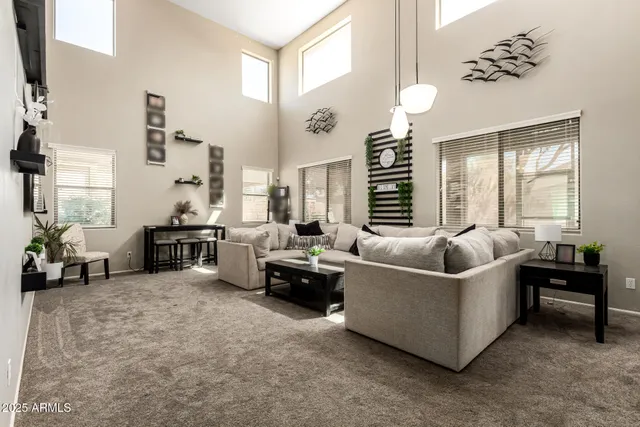 a living room with furniture and a chandelier