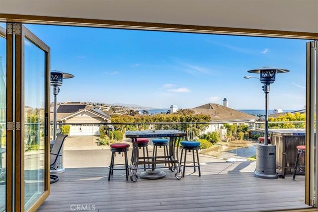 a view of a patio with a table and chairs under an umbrella
