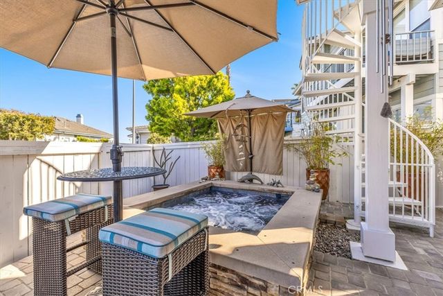 a view of a backyard with table and chairs under an umbrella
