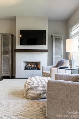 a living room with a bed furniture and a large window