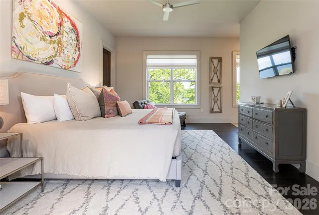 a bedroom with a bed and a painting on the wall