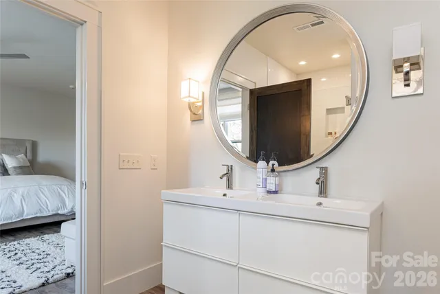 a bedroom with two beds and painting on the wall