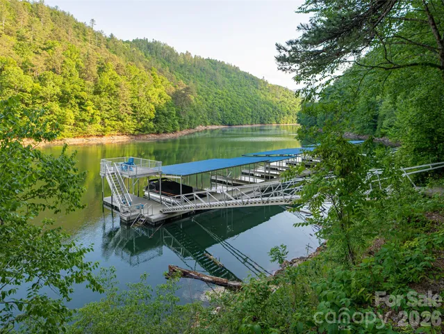a wooden bench sitting in the middle of a lake