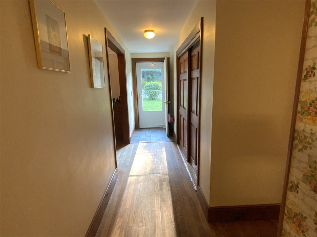 1177 Edgell Road Framingham, MA 01701 - Photo 17 of 32 a view of a hallway with wooden floor and staircase