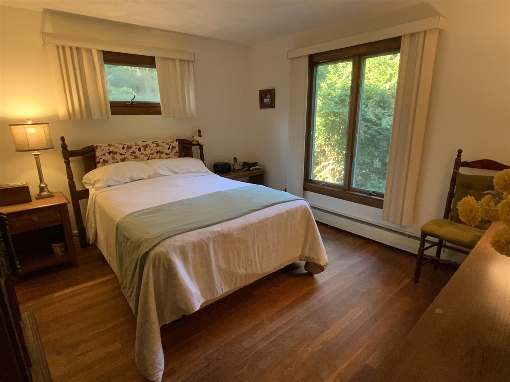 1177 Edgell Road Framingham, MA 01701 - Photo 20 of 32 a bedroom with a bed and wooden floor