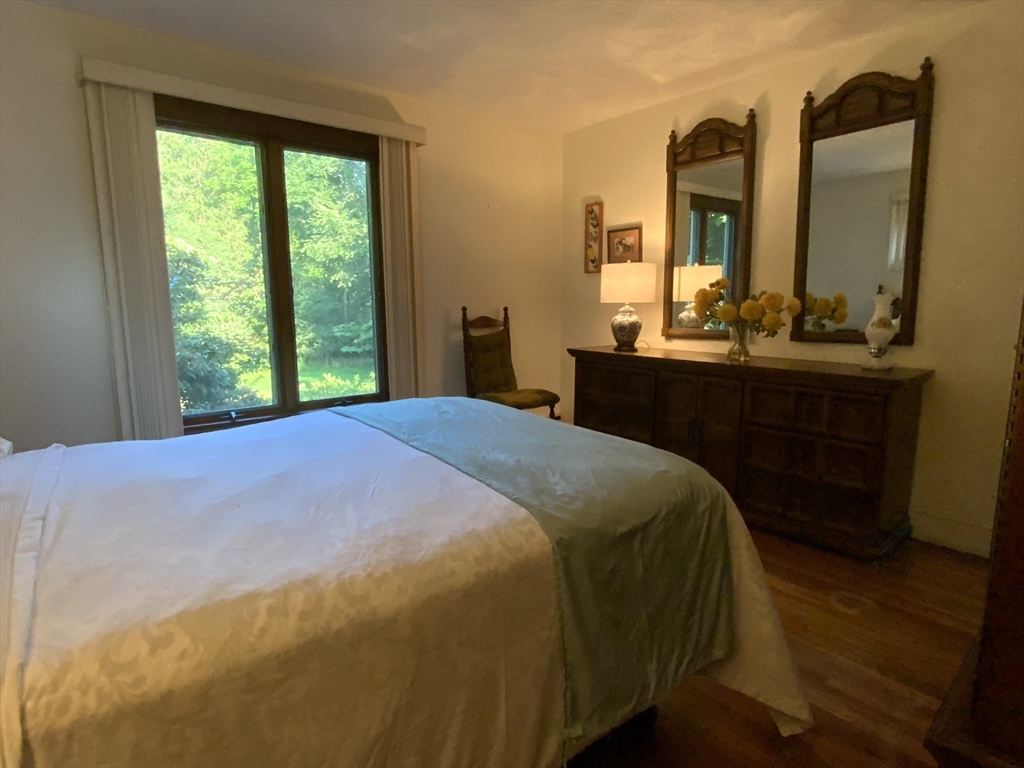 1177 Edgell Road Framingham, MA 01701 - Photo 21 of 32 a spacious bedroom with a bed and a dresser