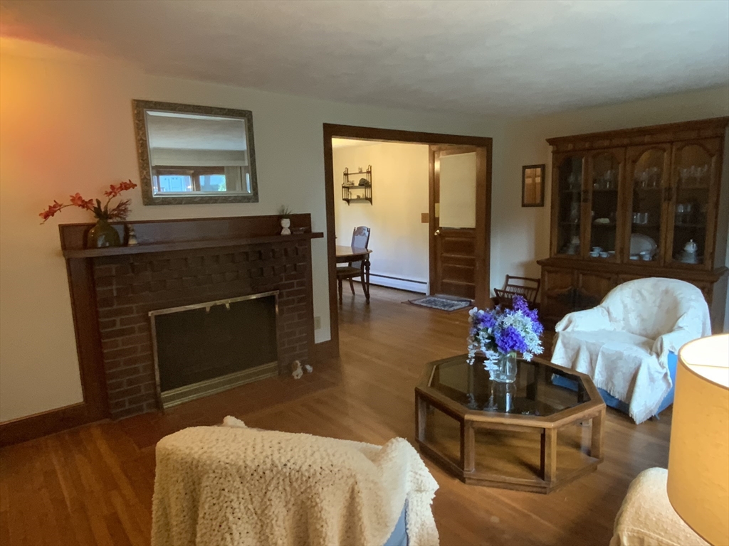 1177 Edgell Road Framingham, MA 01701 - Photo 7 of 32 a living room with furniture a window and a fireplace