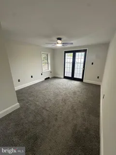 an empty room with windows and closet