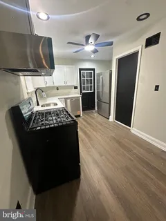 a kitchen with a refrigerator and a stove