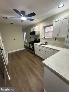 a kitchen with a sink cabinets and window