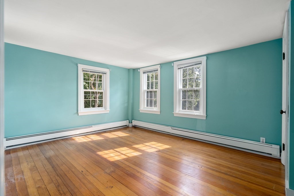 45 Winch Street Framingham, MA 01701 - Photo 26 of 40 an empty room with wooden floor and windows