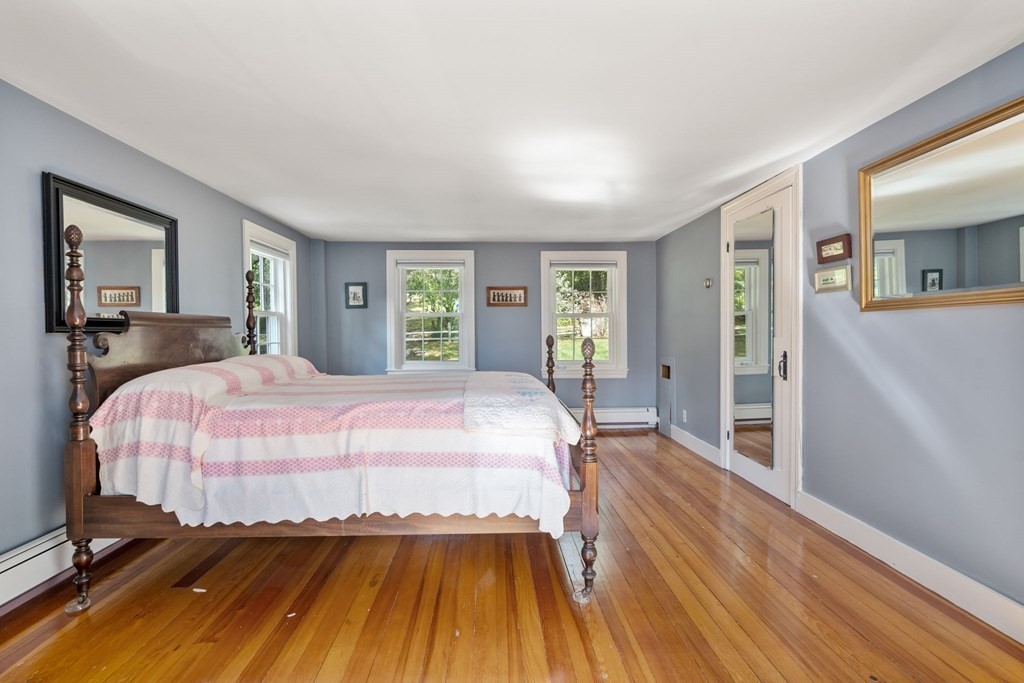 45 Winch Street Framingham, MA 01701 - Photo 31 of 40 a bedroom with a bed and wooden floor