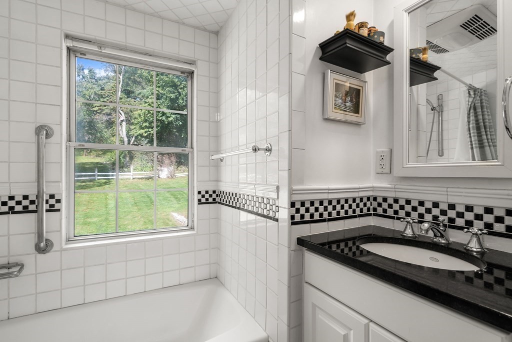 45 Winch Street Framingham, MA 01701 - Photo 32 of 40 a bathroom with a sink a window and a shower
