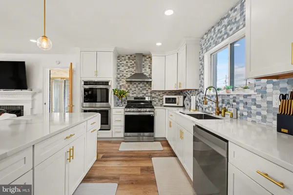a kitchen with stainless steel appliances white cabinets and a stove
