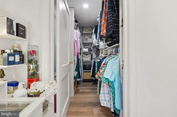 a bedroom with a bed a flat screen tv and a chandelier