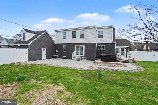 a view of a patio with table and chairs under an umbrella