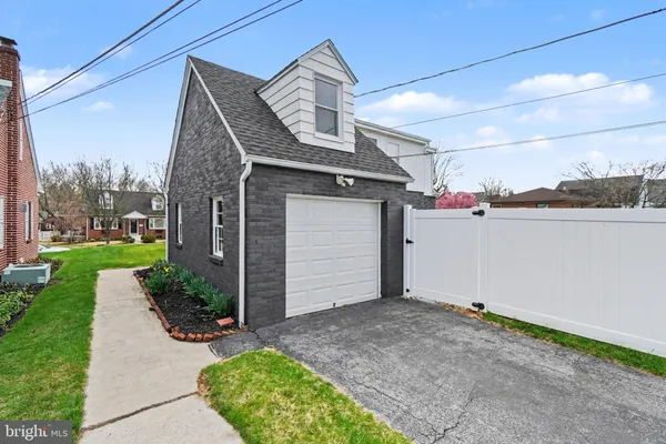 an aerial view of a house with swimming pool and a yard