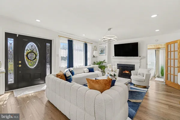 a living room with fireplace furniture and a flat screen tv