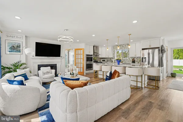 a living room with furniture a flat screen tv and a fireplace