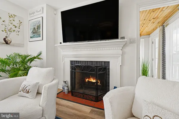 a large kitchen with kitchen island a stove a sink a center island and wooden floor