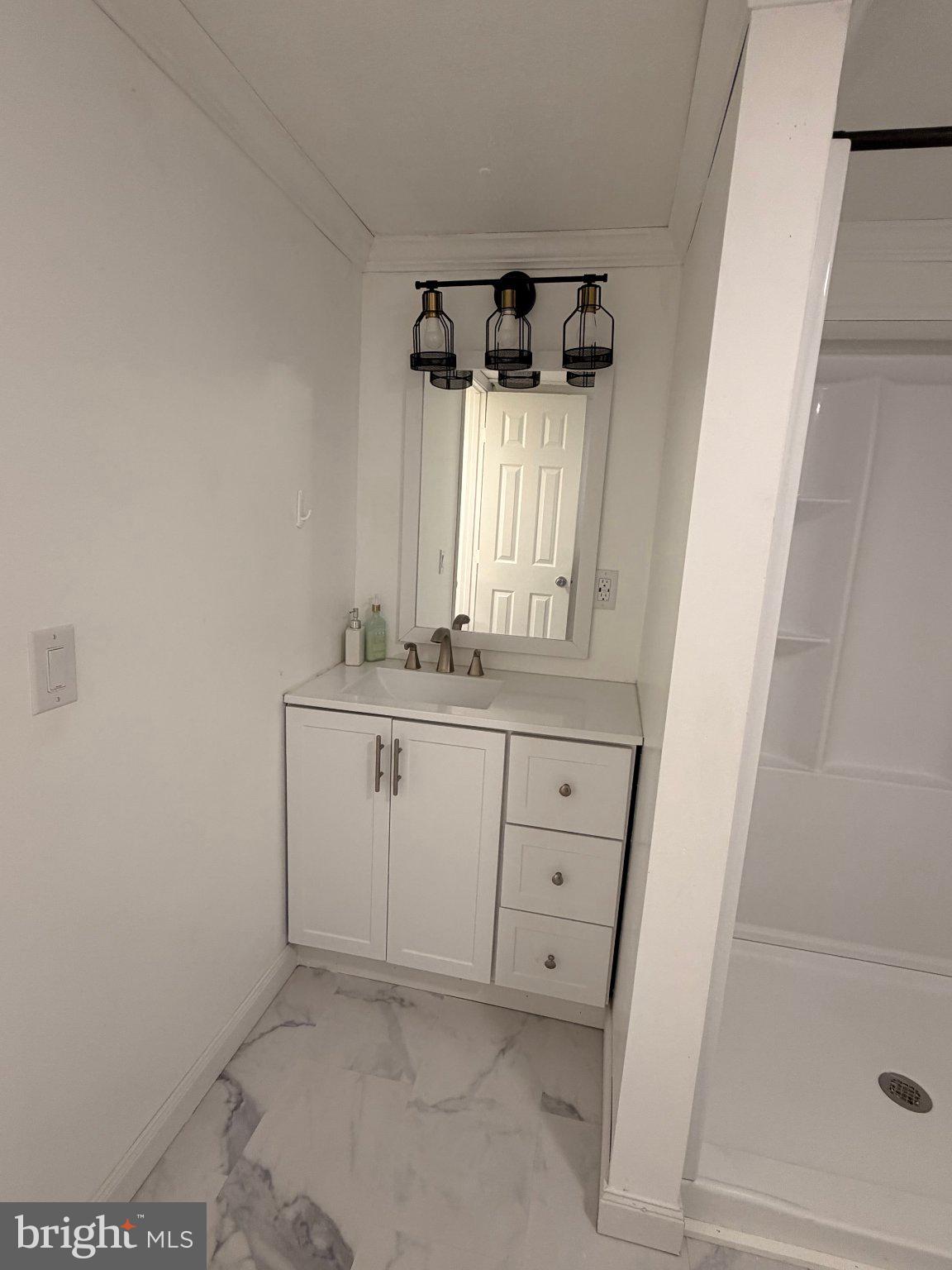 24 Carpenter Street, Unit 24 Dover, DE 19901 - Photo 8 of 27 Sleek modern bathroom with elegance.