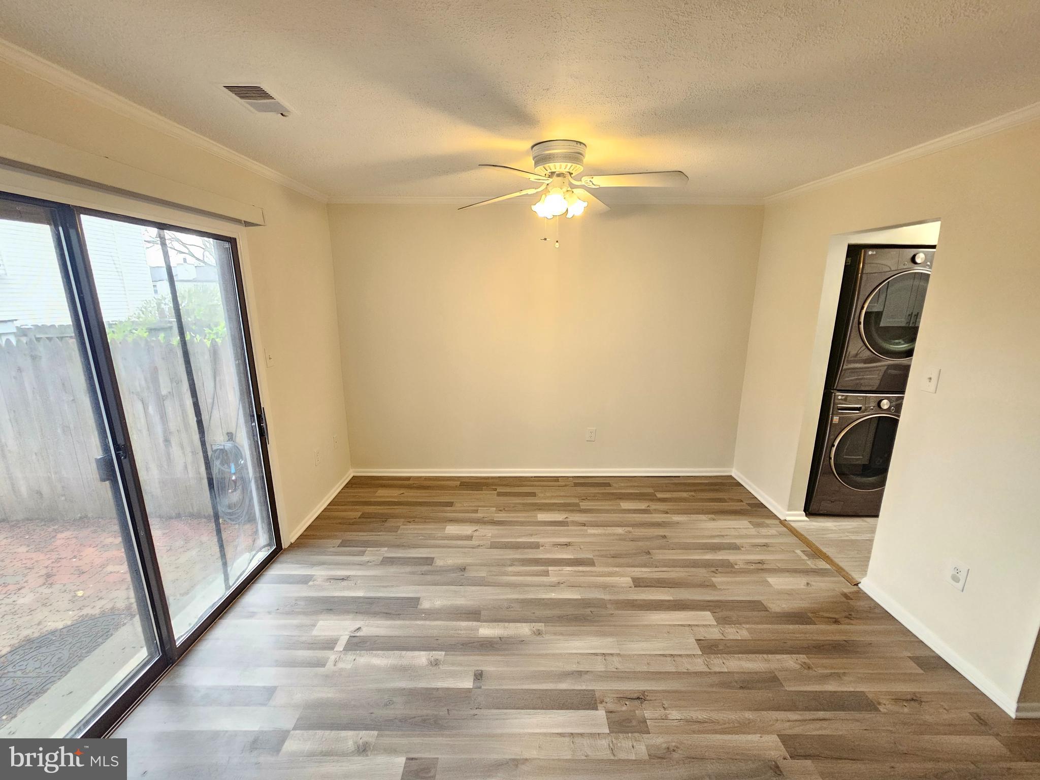 17445 Hoskinson Road Poolesville, MD 20837 - Photo 11 of 37 a view of an empty room with wooden floor and a window
