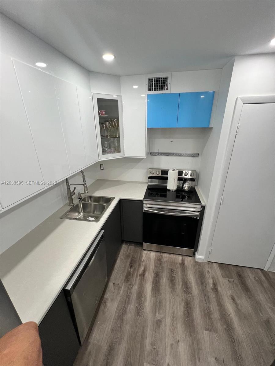4164 Inverrary Drive, Unit 1004 Lauderhill, FL 33319 - Photo 8 of 15 a kitchen with a sink and a stove top oven
