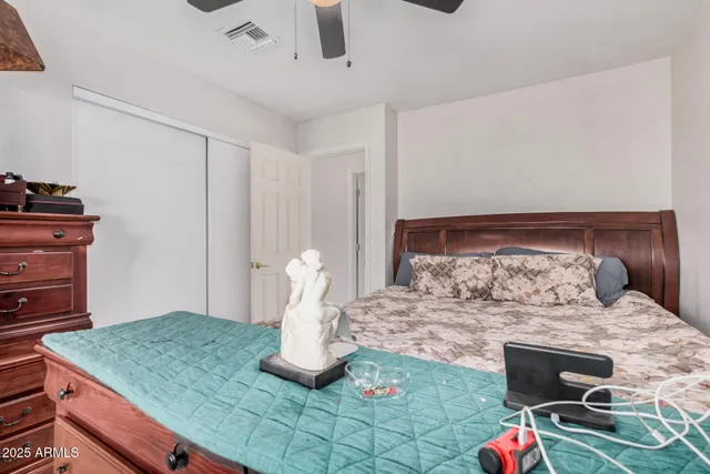 a bedroom with a bed and cabinets