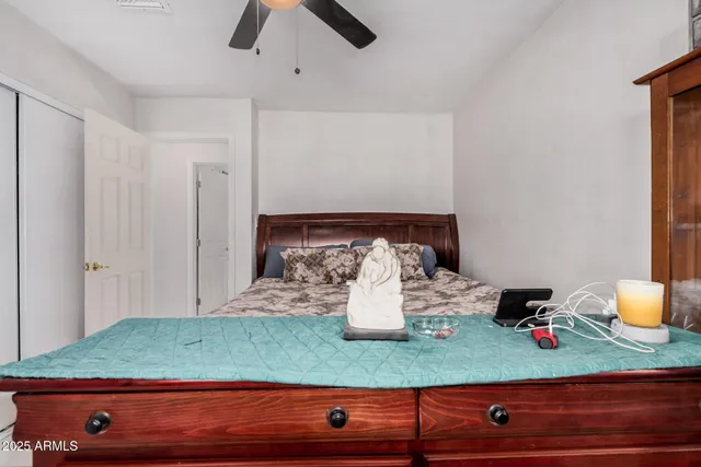 a bedroom with a bed dresser and a window