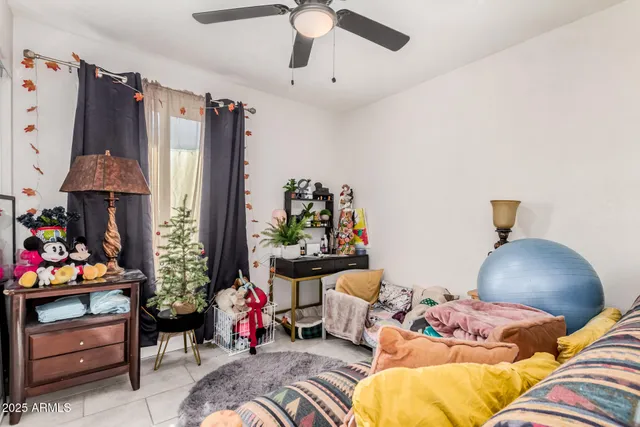 a living room with furniture and flowers