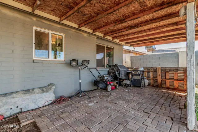 a view of a house with backyard porch and sitting area